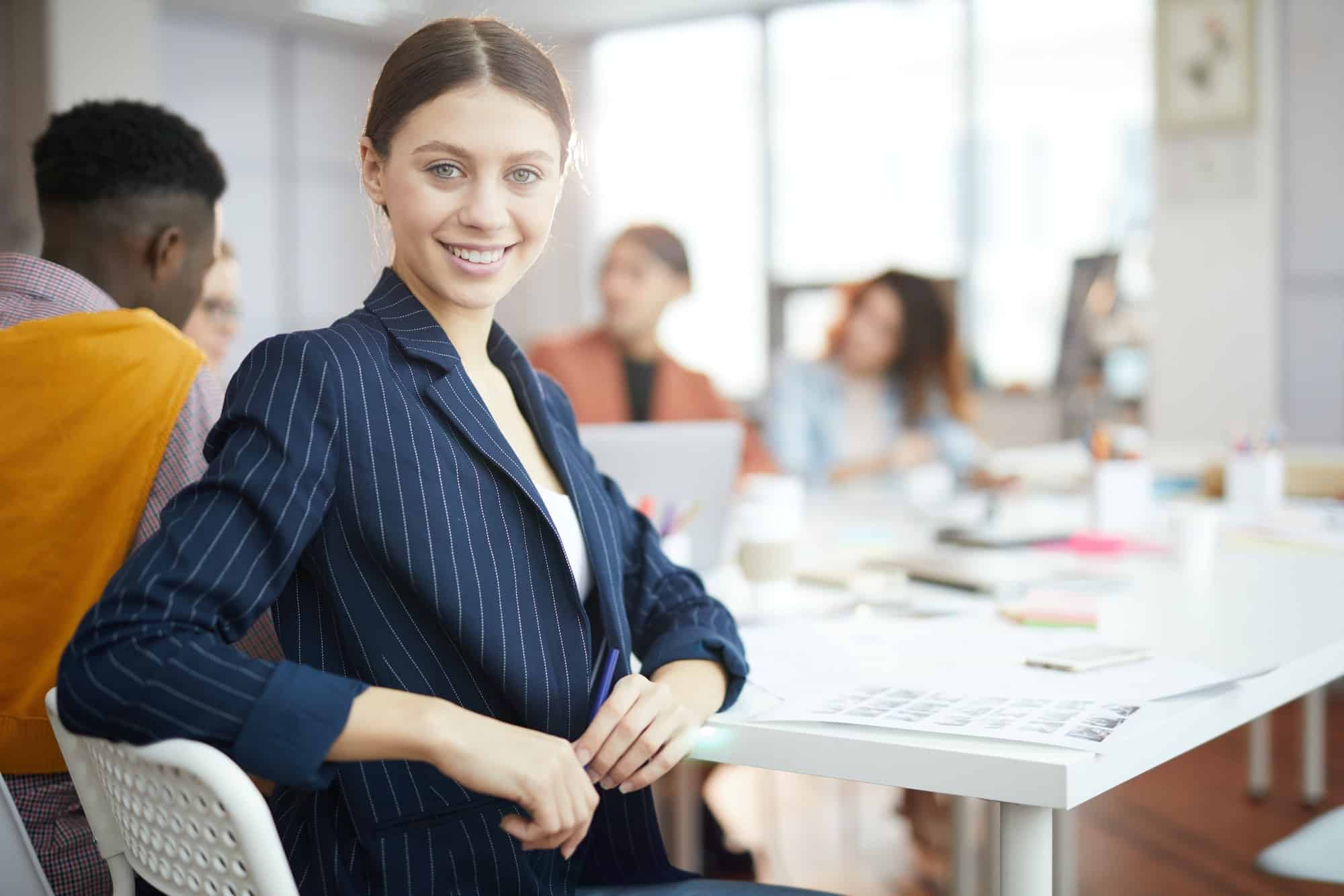 Smiling Businesswoman Posing in Production Agency